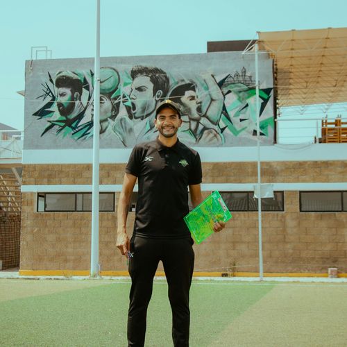 Professional coach Myroslava Stepanenko smiling in a sports studio.